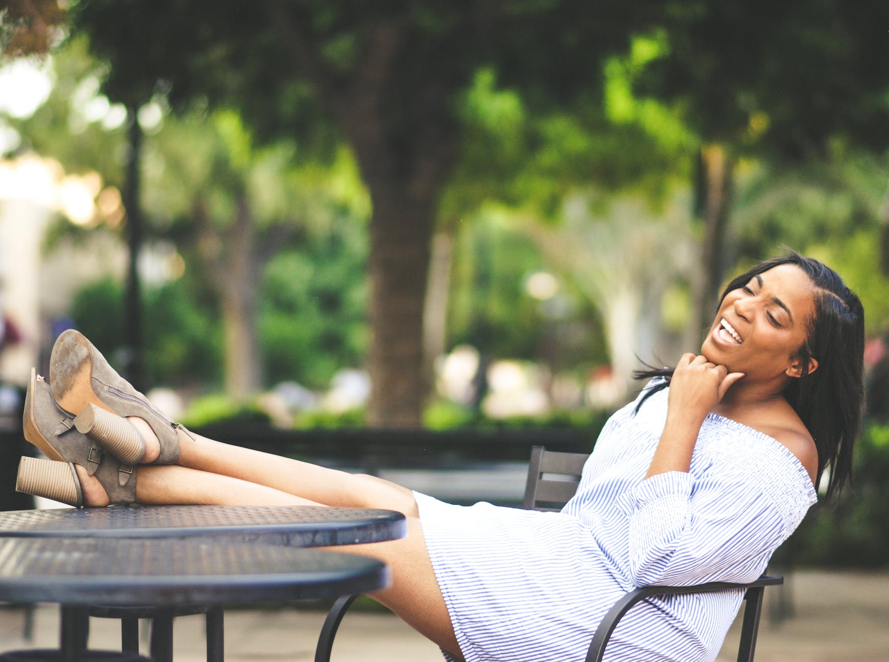 shallow photography on woman sitting on chair