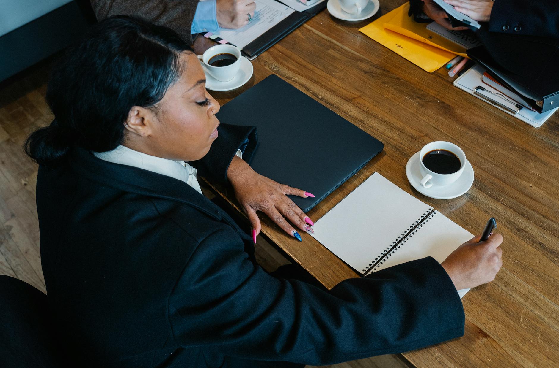 african american businesswoman writing notes in office