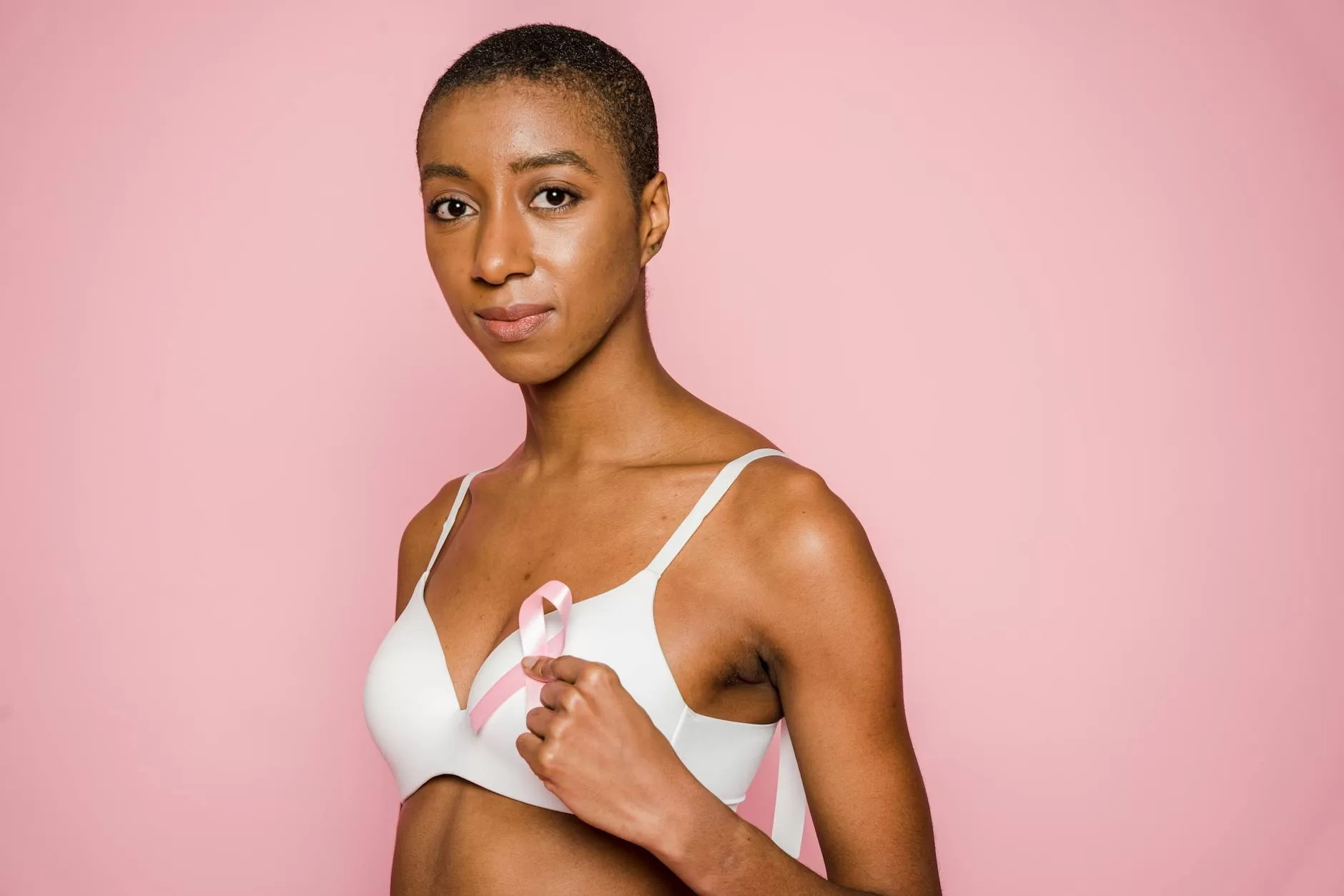 woman holding a pink ribbon